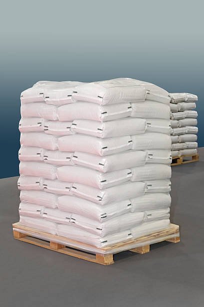White polypropylene sacks at transport pallet Potassium Bicarbonate Food Grade 25kg bag
